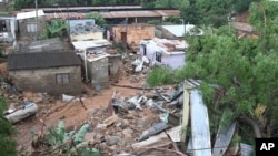 People's homes are seen swept away in Ntuzuma, outside Durban, South Africa, April 12, 2022, following prolonged rains and flooding. 