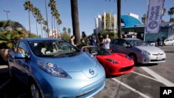 From left, electric cars from Nissan, Tesla, and Toyota are presented at a news conference in Los Angeles on Dec. 13, 2013. (AP Photo/Nick Ut, File)