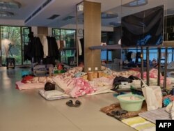 A community worker takes a nap at a temporary bed at a gym in a compound during a COVID-19 lockdown in Pudong district in Shanghai, April 13, 2022.