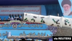 Iranian President Ebrahim Raisi and military commanders watch as military equipment passes by during a ceremony of the National Army Day parade in Tehran, Iran, Apr. 18, 2022. (Iranian Army/WANA (West Asia News Agency)/Handout via Reuters)