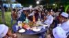 FILE - People praying before they break fast during an event in Narathiwat's Rangae district, Apr. 14, 2022, as Muslim worldwide observe the holy month of Ramadan. 