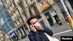 A man wears a protective face mask as he walks along a street, after novel coronavirus has been confirmed in Barcelona, Spain February 25, 2020. 