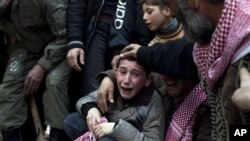 Ahmed menangisi kematian ayahnya yang dibunuh oleh penembak jarak jauh militer Suriah. (AP/Rodrigo Abd)