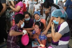 People mourn as they attend the funeral of Thet Paing Soe, who was shot and killed during a protest against the military coup in Yangon, Myanmar, March 20, 2021.