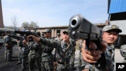 Chinese soldiers practice with their pistols at an undisclosed training camp in central China's Henan province (File)