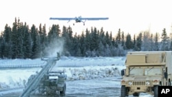 In this Jan. 30, 2014 photo, an unmanned aircraft flies at Joint Base Elmendorf-Richardson in Anchorage, Alaska. U.S. military bases in the Arctic and sub-Arctic are not taking steps against climate change, the Pentagon's watchdog office said recently. (AP Photo/Dan Joling, File)