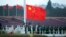 FILE - The Chinese flag is raised at a ceremony on Tiananmen Square in Beijing, March 5, 2016.