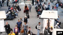 2022年4月19日，在联邦法官宣布对公共交通系统的口罩要求不再有效的一天后，美国科罗拉多州丹佛机场航站楼内一些准备搭机的乘客，已经不再佩戴口罩。