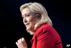 FILE - French far-right leader Marine Le Pen delivers a speech during a meeting in Avignon, France, April 14, 2022. Le Pen is trying to unseat centrist President Emmanuel Macron.