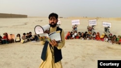 FILE - Matiullah Wesa, Afghan educational activist, reads to students in Afghanistan. (Photo courtesy of Matiullah Wesa)