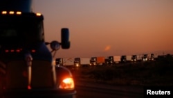 Trucks wait in a queue to cross into the United States in the Jeronimo-Santa Teresa International Bridge connecting the city of Ciudad Juarez to Santa Teresa, Nuevo Mexico, after Texas Governor Greg Abbott a border security agreement with the governor of 