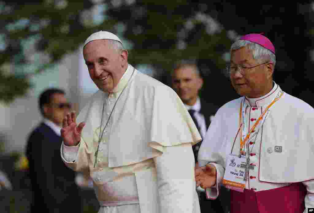 Pope Francis waves during his visit to the birthplace of Saint Kim Taegon Andrea, also known as Saint Andrew Kim Taegon, the first Korean-born Catholic priest, Solmoe Sanctuary in Dangjin, South Korea, Aug. 15, 2014.