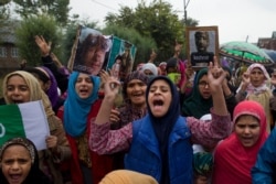FILE - Kashmiris protest after Friday prayers near Srinagar, Indian-controlled Kashmir, Oct. 4, 2019. For two months, mobile phone and internet services have been cut and the region stripped of its semi-autonomous powers.