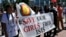 FILE - Women hold a banner during a demonstration marking the first anniversary of Islamic State's surge on Yazidis of the town of Sinjar, in front of the United Nations European headquarters in Geneva, Switzerland, August 3, 2015.