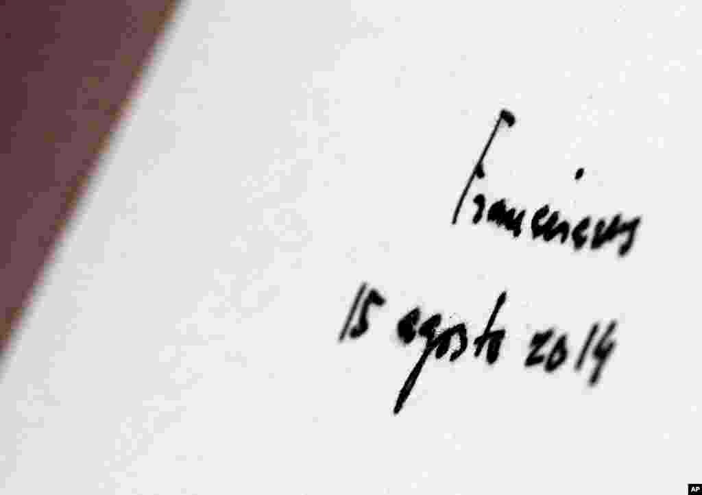 The signature of Pope Francis is seen on the guest book after he prayed in front of the birthplace of Saint Andrea Kim Dae-gun at the Solmoe Sanctuary in Dangjin, South Korea, Aug. 15, 2014.