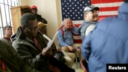 A group of U.S. veterans await a clothing giveaway at St. Anthony Foundation in San Francisco, California November 8, 2013. 