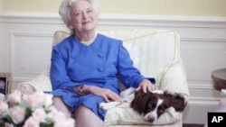 First Lady Barbara Bush poses with her dog Millie in 1990. (AP Photo/Doug Mills)