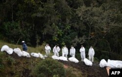 Rescue teams recover the bodies of victims of the LAMIA airlines charter that crashed in the mountains of Cerro Gordo, municipality of La Union, Colombia, Nov. 29, 2016 carrying members of the Brazilian football team Chapecoense Real.