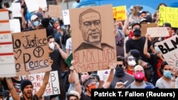 USA, Los Angeles, A demonstrator holds a placard depicting George Floyd during a protest in response to the death in Minneapolis police custody of George Floyd