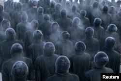 FILE - New recruit People's Liberation Army (PLA) soldiers stand in formation during a training session in cold winter temperatures at a military base in Heihe, Heilongjiang province, China, Nov. 29, 2015.