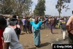 Woman dances before the arrival of Kenyan opposition leader Raila Odinga for a rally in the Nairobi slum of Kibera, Aug. 13, 2017.