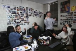 Film club members celebrate as they watch a TV live broadcasting of South Korean director Bong Joon Ho's "Parasite" receiving the award for best picture at the Oscars, at the Yeonsei University in Seoul, South Korea, Monday, Feb. 10, 2020.