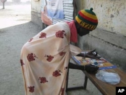 A woman registers to vote in referendum on independence for south Sudan in Jonglei State.