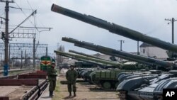 Ukrainian armored vehicles are prepared for loading onto a train at a railway station near Simferopol, Crimea. 