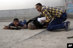 Egyptian security forces help the lifeless body of Giza Police Chief Gen. Nabil Farag, center, who was killed after unidentified militants opened fire on security forces in Kerdasa, Sept. 19, 2013.
