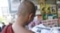 A Buddhist monk reads a journal at a roadside shop in Rangoon, Burma, Tuesday, Feb. 28, 2012. 