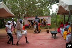 The environmental activist Modou Fall, who many simply call "Plastic Man," takes part in an event about environmental health and pollution management in Dakar, Senegal, Nov. 8, 2022.