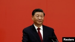 FILE - Chinese President Xi Jinping speaks as new Politburo Standing Committee members meet the media following the 20th National Congress of the Communist Party of China, at the Great Hall of the People in Beijing, Oct. 23, 2022.