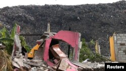 A damaged house is seen during a rescue mission after a garbage dump collapsed and buried dozens of houses in Colombo, Sri Lanka, April 15, 2017.