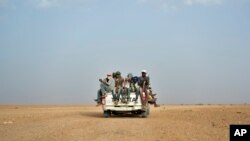 FILE - Nigeriens and third-country migrants head towards Libya from Agadez, Niger, June 4, 2018. Algeria’s deadly expulsions of migrants into the Sahara Desert have nearly ground to a halt after widespread condemnation and the abrupt firing of two of its top security officials. 