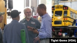 Tashitaa Tufaa chats with mechanics and drivers at Metropolitan Transportation Network’s maintenance shop in Fridley, Minnesota, Aug. 10, 2017.