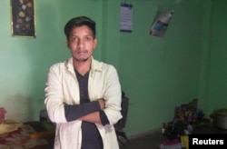 Satish Bhaykre, 21, who was beaten by a mob due to a fake WhatsApp text, poses inside his house on the outskirts of Nagpur, India, June 23, 2018.