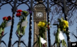 Floral tributes to the victims of the Westminster terrorist attack are placed outside the Palace of Westminster, London, March 27, 2017.