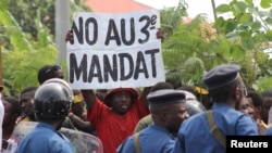A protester holds a placard at a rally opposing Burundi President Pierre Nkurunziza's bid for a third five-year term in office, in Bujumbura, May 4, 2015.