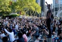 A group of protesters take a knee while marching in lower Manhattan, Saturday, June 6, 2020, in New York. Protests continued following the death of George Floyd, who died after being restrained by Minneapolis police officers on May 25.