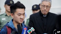 Chan Tong-kai, left, talks to the media as he is released from prison in Hong Kong Wednesday, Oct. 23, 2019. (AP Photo/Mark Schiefelbein)