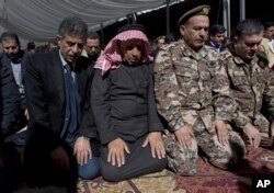 Safi al-Kaseasbeh, third right, father of slain Jordanian pilot, Lt. Muath al-Kaseasbeh attends a mass funeral at the Kaseasbeh tribe's gathering divan at their home village of Ai, near Karak, Jordan, Feb. 4, 2015.