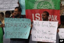 FILE - People protest against an Islamic State-claimed attack on a shrine earlier this year, in Peshawar, Pakistan, Feb. 17, 2017.