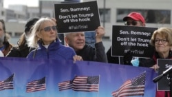 Scott Riching, center, gathers with others outside the office of Sen. Mitt Romney to call on him to push for a full and fair impeachment trial in the Senate during a rally Thursday, Jan. 16, 2020, in Salt Lake City.
