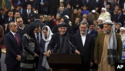 Afghanistan's President Ashraf Ghani, center, speaks to journalists after arriving to register as a candidate for the presidential election at the Independent Elections Commission, in Kabul, Jan. 20, 2019. 