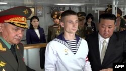 In this image taken from a handout video released on Sept. 16, 2023, by the Russian Defense Ministry, North Korean leader Kim Jong Un and Russian Defense Minister Sergei Shoigu visit the Marshal Shaposhnikov frigate of the Russian Pacific fleet.