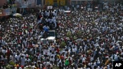 Protesters led by the art community demand the resignation of Haitian President Jovenel Moise as they march through Port-au-Prince, Haiti, Oct. 13, 2019.
