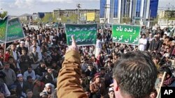 An Afghan protester, Sediq Afghan, talks to demonstrators in Kabul, Afghanistan, after seven United Nations staff members were killed in an attack on a UN compound in northern Afghanistan, April 1, 2011