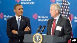 President Barack Obama is introduced by W. James McNerney, Jr., CEO of Boeing (R), before speaking to members of the Business Roundtable, a trade group representing America's big businesses, in Washington, Sept. 18, 2013.