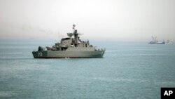 A woman sells &quot;Happy New Year 2017&quot; headwear on a shopping street in Sydney, Australia.