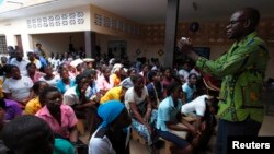 FILE - Youths attend a talk on sexual and domestic violence and HIV/AIDS prevention in Agoe-Nyive, a suburb of Lome. 